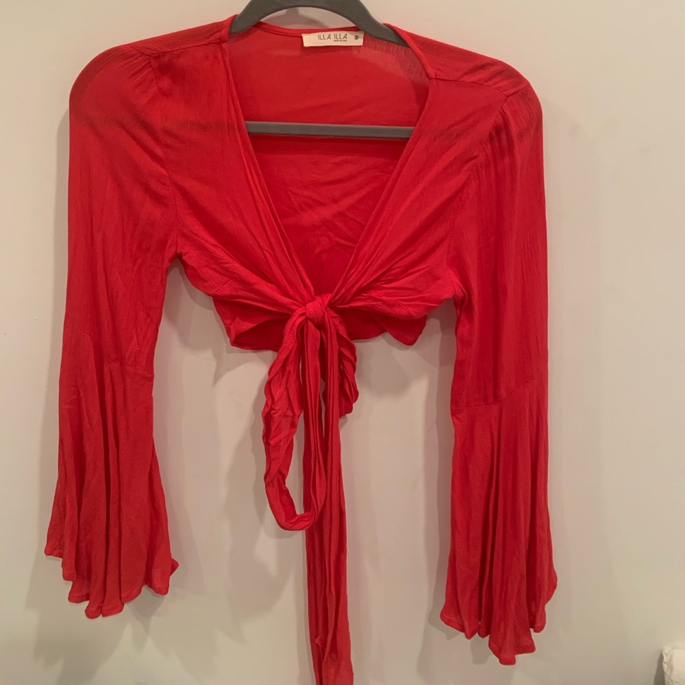 wrap crop top. Sleeves are bell bottom looking.